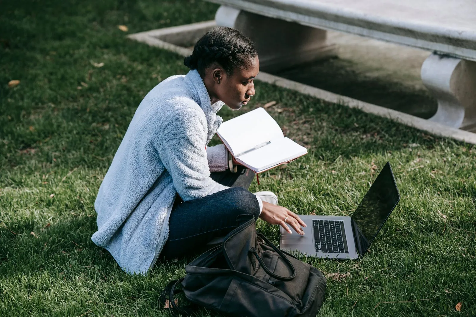 A young student working independently on a university campus